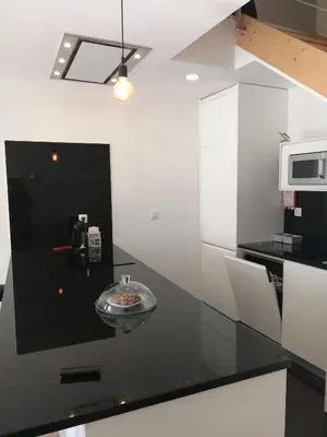 a kitchen with a black counter top with a sink at Casa Ventuzelo in Porto