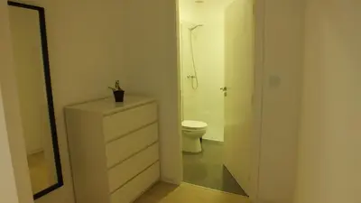a bathroom with a toilet and a white dresser at Casa Ventuzelo in Porto