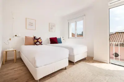 a white bedroom with two beds and a couch at Gaia Retreat • 2 BD · A/C in Vila Nova de Gaia