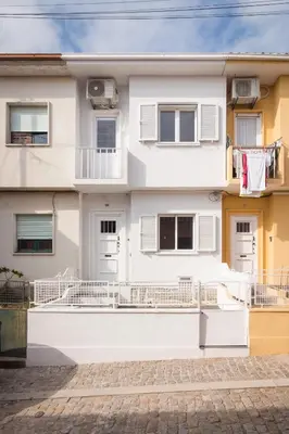 a white house with clothes hanging on a balcony at Gaia Retreat • 2 BD · A/C in Vila Nova de Gaia