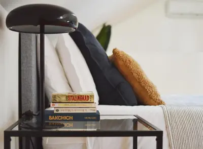 a stack of books on a table next to a couch at Elisa Apartment in Porto