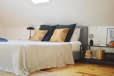 a bedroom with a bed with pillows on it at Elisa Apartment in Porto