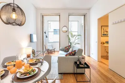 a living room with a table with food on it at Apartamentos Villa Bolhao in Porto