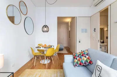a living room with a blue couch and a table at Apartamentos Villa Bolhao in Porto