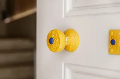a gold door knob on a white door at YOUROPO - ExtendALL in Porto