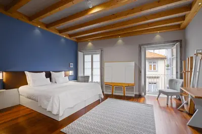 a bedroom with a white bed and a blue wall at YOUROPO - ExtendALL in Porto