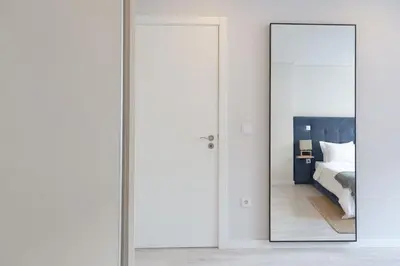 a mirror in front of a bedroom with a bed at Marquês Deluxe Apartment in Porto
