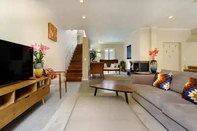 a living room with a couch and a tv at Casas Da Formiga - Riverview Terrace and Pool in Porto