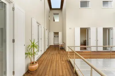 a hallway with white walls and a wooden floor at Casas Da Formiga - Riverview Terrace and Pool in Porto