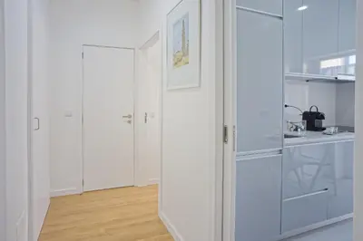 a white kitchen with white cabinets and a sink at Luxury Anibal Cunha Apartments in Porto