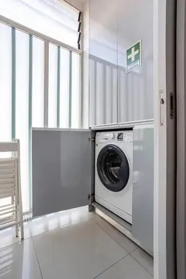 a washing machine in a room with a window at Luxury Anibal Cunha Apartments in Porto
