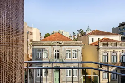 a view of an old building from a balcony at Luxury Anibal Cunha Apartments in Porto