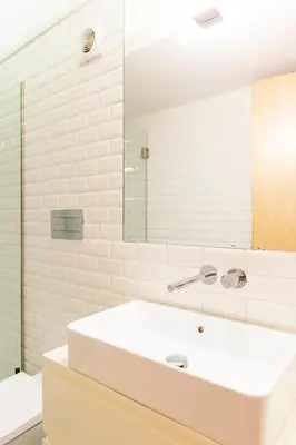 a white bathroom with a sink and a mirror at APOSENTUS - Charming Center Apartment with Balcony in Porto