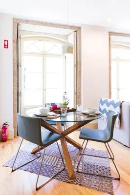 a dining room with a table and chairs at APOSENTUS - Charming Center Apartment with Balcony in Porto