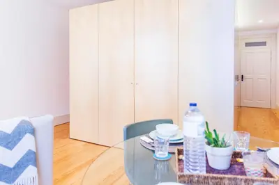 a glass table and chairs in a room at APOSENTUS - Charming Center Apartment with Balcony in Porto