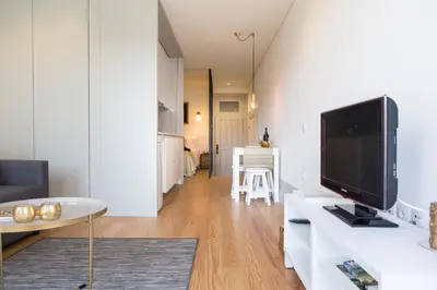 a living room with a flat screen tv on a counter at Casa D'ouro in Porto