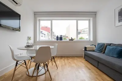 a living room with a table and a couch at Casa da Luz - Lighthouse of Porto in Porto