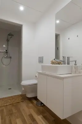a white bathroom with a sink and a toilet at Casa da Luz - Lighthouse of Porto in Porto