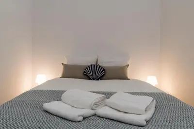 a bed with white towels on top of it at Casa da Luz - Lighthouse of Porto in Porto
