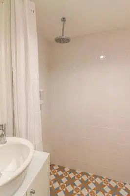 a bathroom with a white sink and a shower at PORTO CONCEPT HOME - Paranhos in Porto