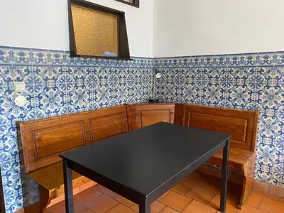 a black table in a kitchen with blue and white tiles at Casa dos Azulejos in Porto