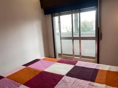 a bedroom with a colorful bed with a window at Casa dos Azulejos in Porto