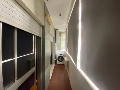 a hallway of a house with a washing machine at Casa dos Azulejos in Porto
