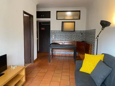 a living room with a couch and a table at Casa dos Azulejos in Porto