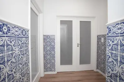 a room with blue and white walls and a door at Downtown 3 Bedroom with Balcony - Quiet Street - Family Friendly - Groups in Porto