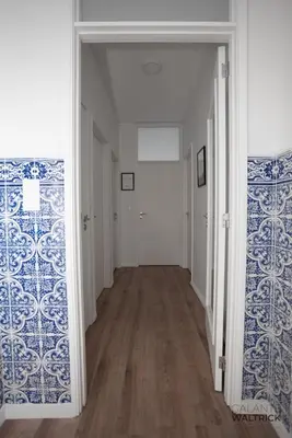 an empty hallway with blue and white wallpaper at Downtown 3 Bedroom with Balcony - Quiet Street - Family Friendly - Groups in Porto