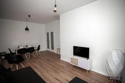 a living room with a television and a dining table at Downtown 3 Bedroom with Balcony - Quiet Street - Family Friendly - Groups in Porto