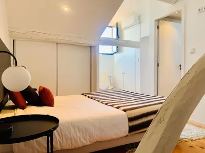 a bedroom with a bed and a table at Oporto Chic&Cozy - Santo Ildefonso in Porto