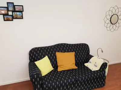 a black couch with two yellow pillows on it at Porto Central City Heart I & II in Porto