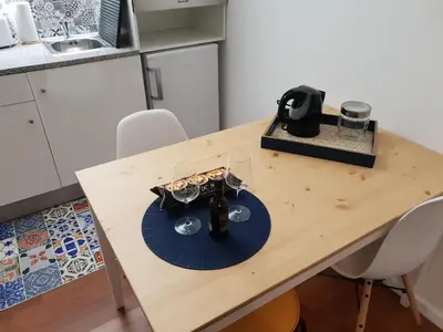 a table with wine glasses on it in a kitchen at Porto Central City Heart I & II in Porto