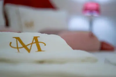 a pillow with the wordax written on it on a bed at Port Wine Flats in Vila Nova de Gaia