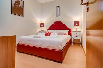 a bed with a red headboard in a bedroom at Port Wine Flats in Vila Nova de Gaia