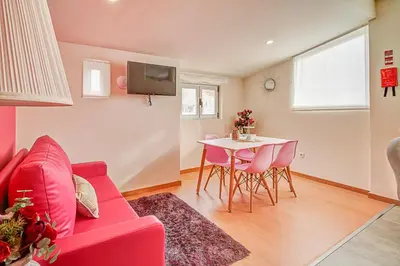 a living room with a red couch and a table at Port Wine Flats in Vila Nova de Gaia