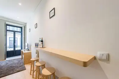 a kitchen with a counter and stools in a room at VIVA Historic Centre Downtown in Porto