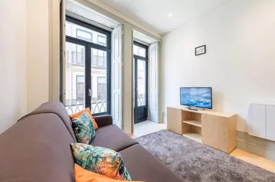 a living room with a couch and a tv at VIVA Historic Centre Downtown in Porto
