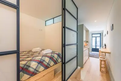 a bedroom with a bed and a sliding glass door at VIVA Historic Centre Downtown in Porto