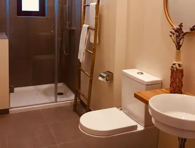 a bathroom with a toilet and a shower and a sink at Sweet Swell in Porto