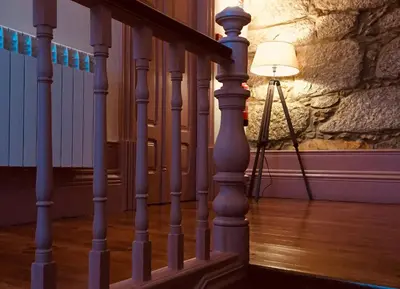 a lamp on a tripod next to a stair case at Sweet Swell in Porto