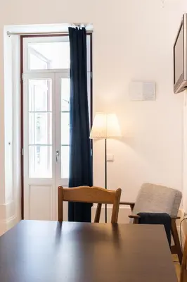 a dining room with a table and a window at VIVA Breiner Flats in Porto