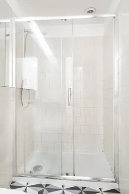 a shower with a glass door in a bathroom at VIVA Breiner Flats in Porto