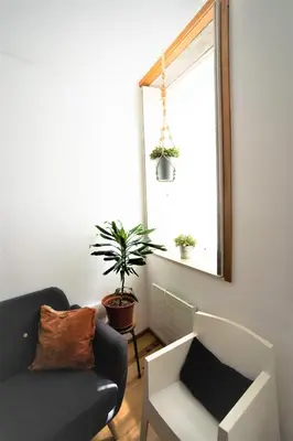 a living room with a couch and a window at Downtown Porto Relaxed Apartment with Private Yard in Porto