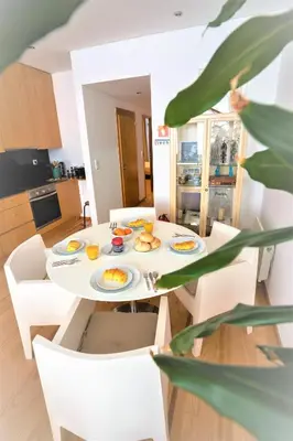 a table with plates of food on it in a kitchen at Downtown Porto Relaxed Apartment with Private Yard in Porto