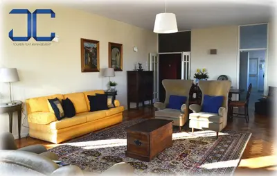 a living room with yellow couches and chairs at Pardal Apartment by JC in Porto