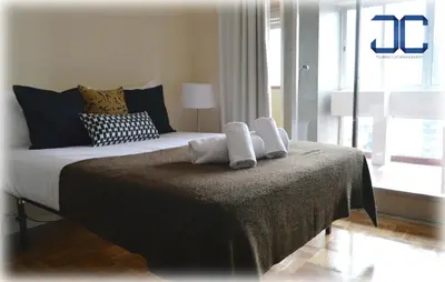 a bedroom with a bed with two towels on it at Pardal Apartment by JC in Porto