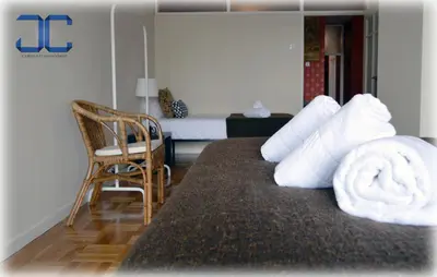 a room with a bed with a pile of towels on it at Pardal Apartment by JC in Porto