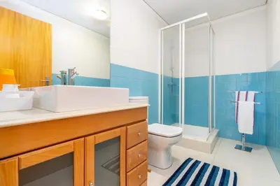 a bathroom with a sink and a shower and a toilet at Cedofeita Exclusive with parking included in Porto